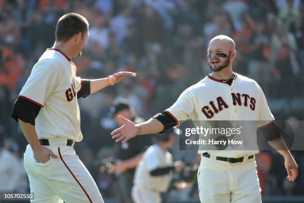 Cody Ross and Aubrey Huff of the San Francisco Giants celebrate a two run fourth inning against the Philadelphia Phillies in Game Three of the NLCS...