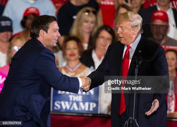 President Donald Trump welcomes Florida gubernatorial candidate Ron DeSantis to the stage at a campaign rally at the Pensacola International Airport...