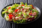 Mediterranean salad with tuna fish, borlotti beans, cherry tomatoes, lettuce close-up. horizontal
