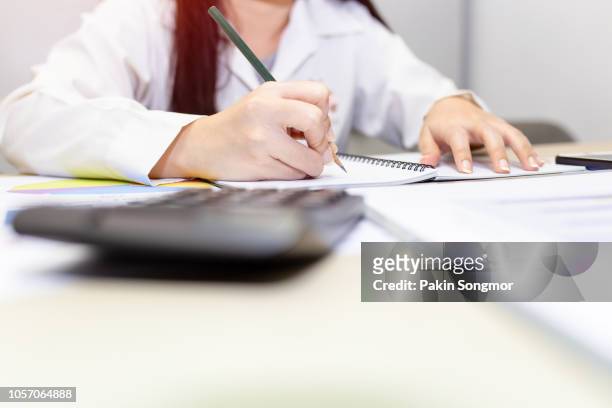 close up right hand female with pencil on notebook - kids certificate stock pictures, royalty-free photos & images