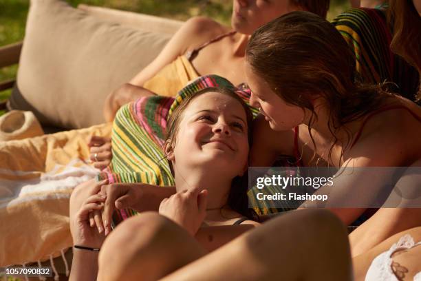 group of friends relaxing by swimming pool at home - hot spanish women fotografías e imágenes de stock