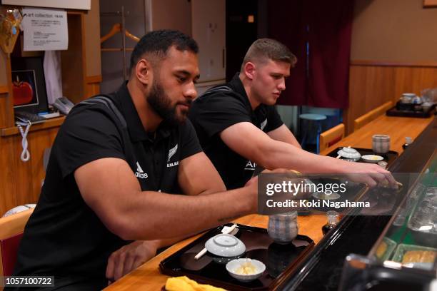 Dalton Papalii and Patrick Tuipulotu of the New Zealand All Blacks taste sushi at Kosushi restaurant on October 20, 2018 in Tokyo, Japan.