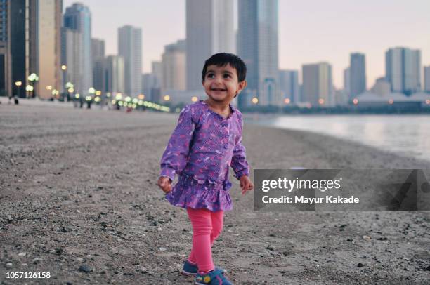 toddler having fun at beach - expatriate stock pictures, royalty-free photos & images