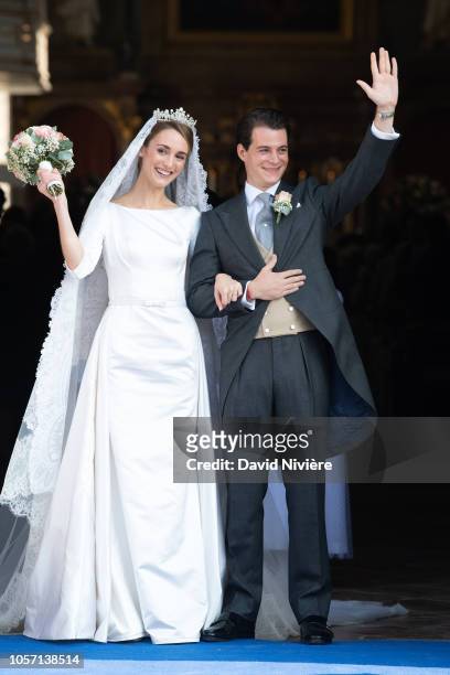 Duchess Sophie of Wurtemberg and Count Maximilien of Andigne get out of the Saint-Quirin church after their wedding at the Castle of Tegernsee on...