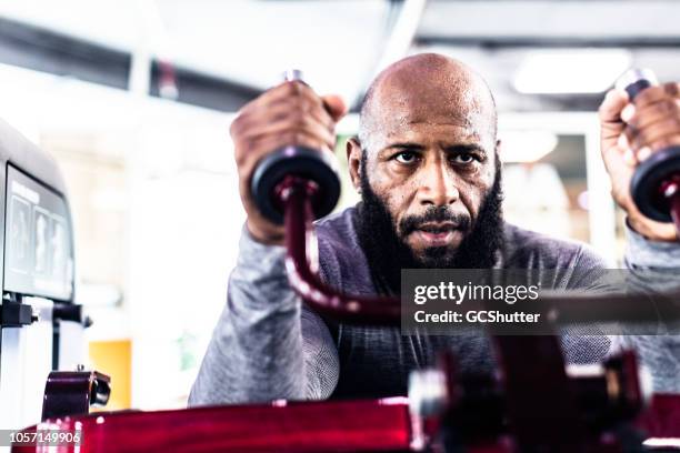 man working out at a fitness center - dubai fitness stock pictures, royalty-free photos & images