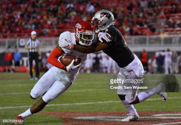 Wide receiver KeeSean Johnson of the Fresno State Bulldogs runs after catching a pass against defensive back Alex Perry of the UNLV Rebels during...