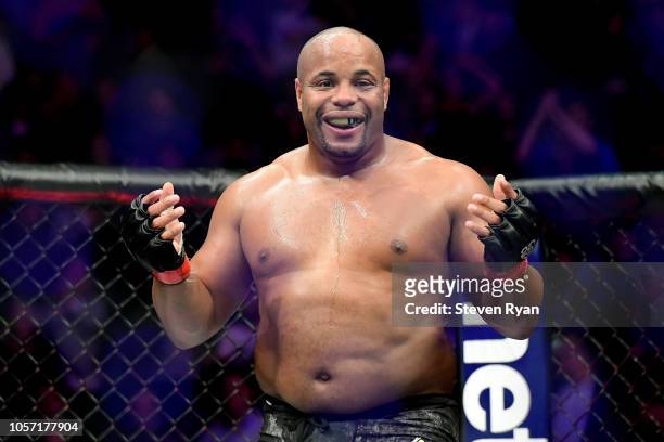 Daniel Cormier of the United States celebrates his win by submission over Derrick Lewis of the United States in their heavyweight title bout during...