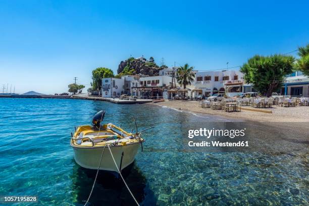 greece, patmos, skala, boat in a bay - dodecanese islands stock-fotos und bilder