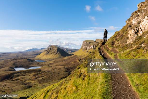 uk, scotland, inner hebrides, isle of skye, trotternish, hiking trail at quiraing, loch cleat, hiker looking at view - highlands schottland wandern stock-fotos und bilder