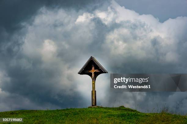 germany, bavaria, allgaeu, allgaeu alps, wayside cross with jesus figurine in front of dramatic sky - jesus calming the storm stock pictures, royalty-free photos & images