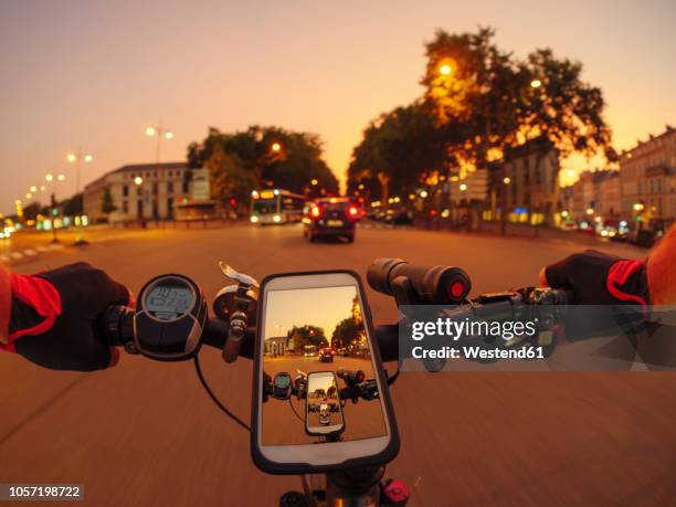 france, versailles, personal perspective of man riding e-bike on avenue de l'europe at twilight - fish eye photos et images de collection