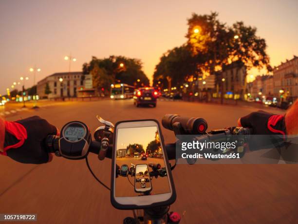 france, versailles, personal perspective of man riding e-bike on avenue de l'europe at twilight - single lane road - fotografias e filmes do acervo