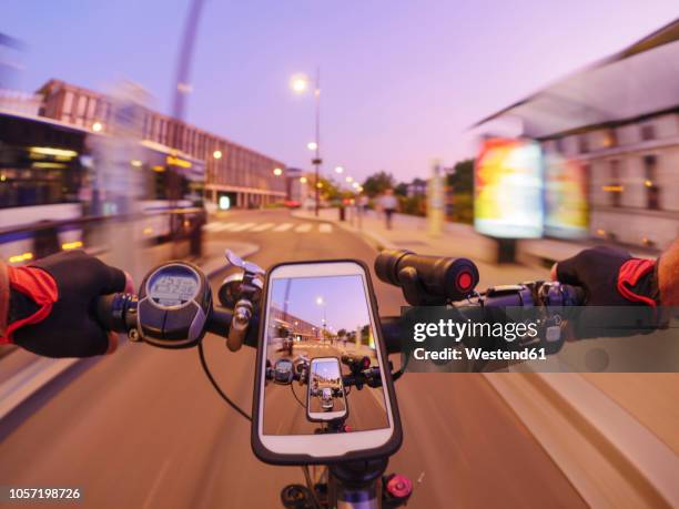 france, versailles, personal perspective of man riding e-bike on avenue de l'europe at twilight - wonder film 2017 stockfoto's en -beelden