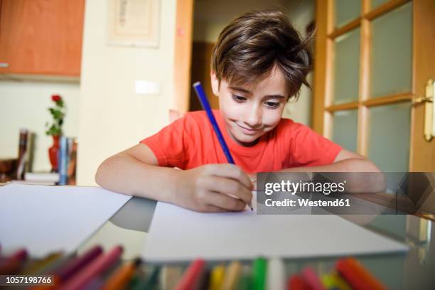 portrait of smiling little girl drawing with coloured pencils at home - draw attention stock pictures, royalty-free photos & images