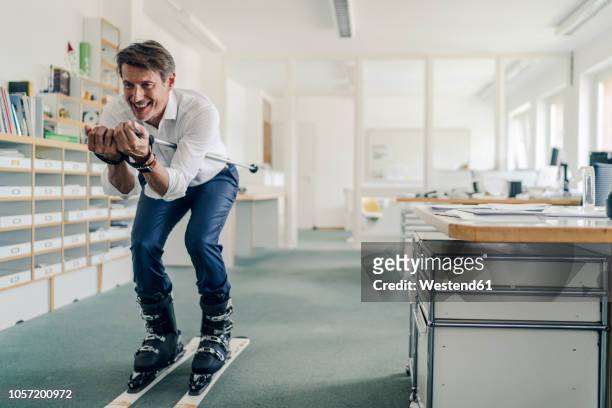 businessman skiing in office - dreams stock photos et images de collection