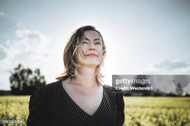 portrait of woman in rape field - finland happy stock pictures, royalty-free photos & images