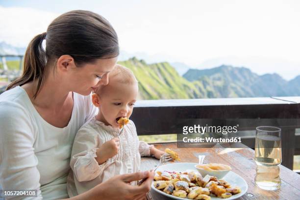 germany, bavaria, oberstdorf, mother and little daughter having lunch at a mountain hut - kaiserschmarrn stock pictures, royalty-free photos & images