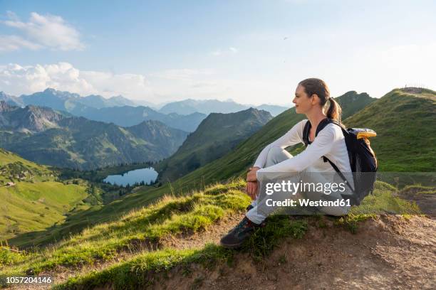 germany, bavaria, oberstdorf, woman on a hike in the mountains having a break - bavaria mountain stock pictures, royalty-free photos & images