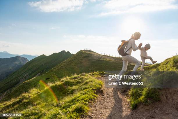 germany, bavaria, oberstdorf, mother and little daughter on a hiking trip in the mountains - girl mound stock-fotos und bilder