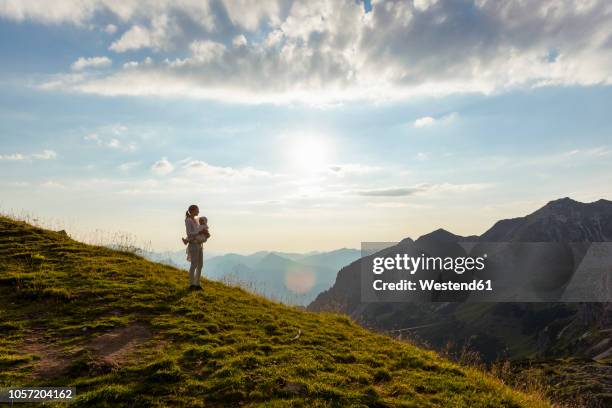 germany, bavaria, oberstdorf, mother and little daughter on a hike in the mountains looking at view at sunset - observation point stock pictures, royalty-free photos & images