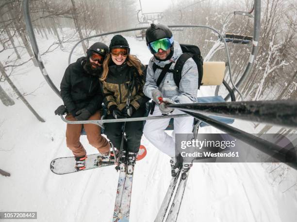 italy, modena, cimone, portrait of happy friends taking a selfie in a ski lift - monopod winter stock pictures, royalty-free photos & images