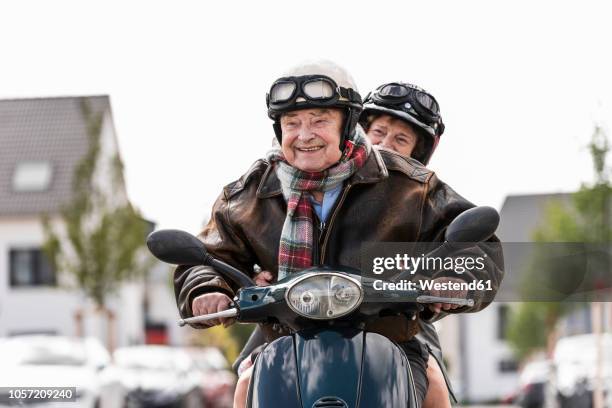 happy senior couple riding motor scooter - man with scooter bildbanksfoton och bilder