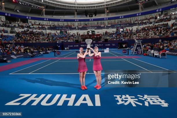 Lyudmyla Kichenok of Ukraine and Nadiia kichenok of Ukraine pose with their trophy after defeating Lidziya Marozava of Belarus and Shuko Aoyama of...