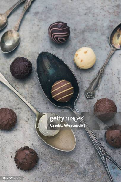 various chocolate truffles and old spoons - chocolate truffle stock pictures, royalty-free photos & images