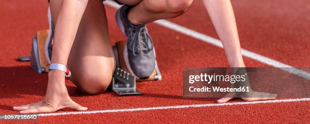 female runner in starting position, - track and field event stock pictures, royalty-free photos & images