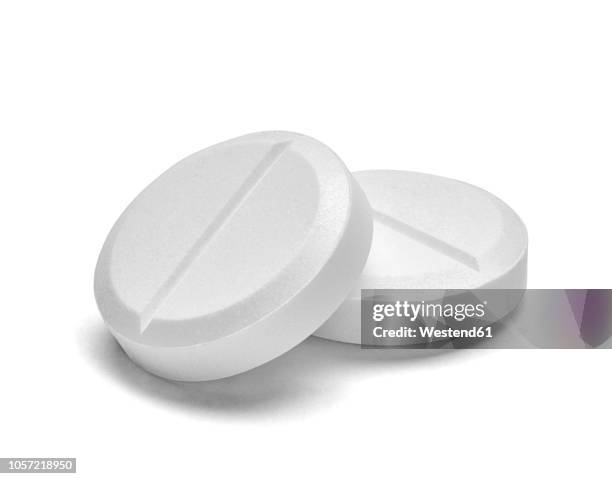 two white pills on white background, close-up - round pill stock pictures, royalty-free photos & images