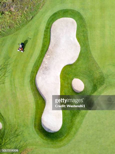 indonesia, bali, aerial view of golf course - golf bunker stock-fotos und bilder