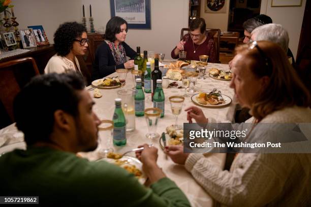 Myriam Gumerman center, enjoys the company of her friends as they gather to celebrate the Shabbat at her home on Friday, November 2, 2018 in...