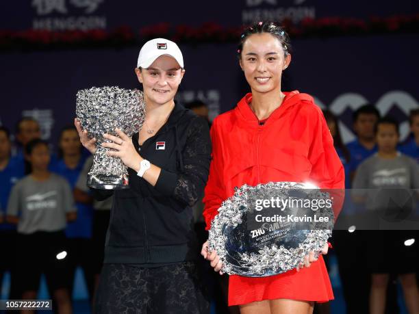 Winner Ashleigh Barty of Australia and runner up Wang Qiang of China pose with their trophies after the Women's Single final match on Day 6 of 2018...