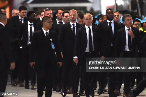 Leicester City's goalkeeper Kasper Schmeichel , manager Claude Puel with other team members and officials arrive at Wat Thepsirin Buddhist temple in...