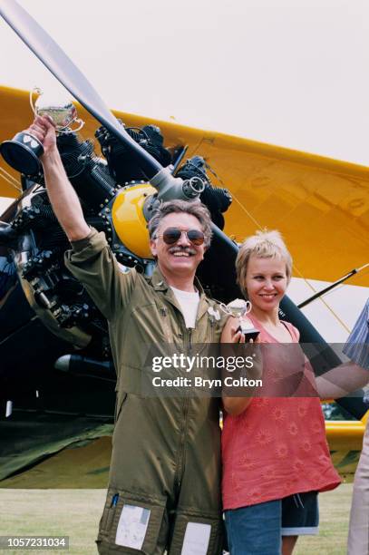 Martin Shaw, actor and televison star wife his wife Vicky Kimm, a television presenter, stand by Shaw's wartime Boeing Stearman aircraft after a...