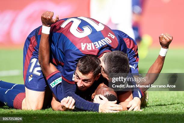 Papakouli Diop of SD Eibar celebrates with his teammates Sergi Enrich and Paulo Oliveira of SD Eibar after scoring his team's second goal during the...