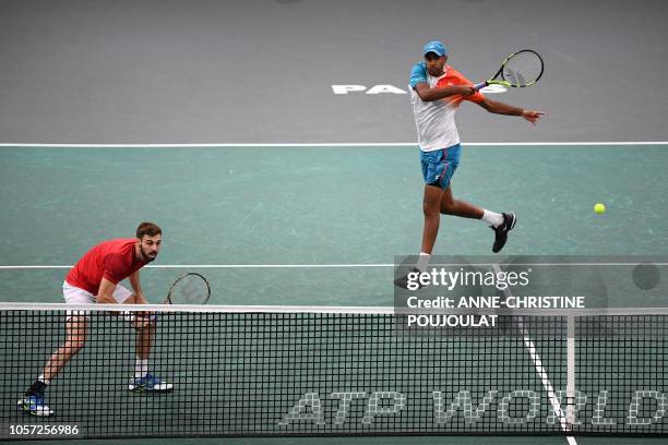 Spain's Marcel Granollers and Rajeev Ram of the US, return the ball to Netherlands' Jean-Julien Rojer and Romania's Horia Tecau, during their men's...