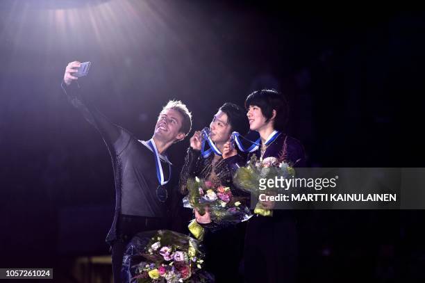 Silver medalist Michal Brezina of Czech Republic, gold medalist Yuzuru Hanyu of Japan and bronze medalist Junhwan Cha of South Korea pose for a...