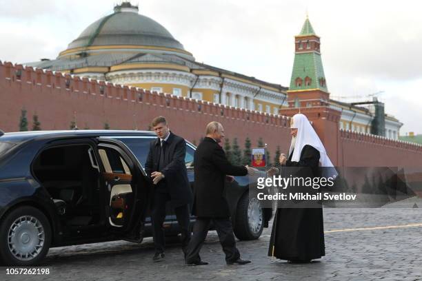 Russian President Vladimir Putin greets Russian Orthodox Patriarch Kirill during the flower laying ceremony at Red Square in Moscow, Russia, November...