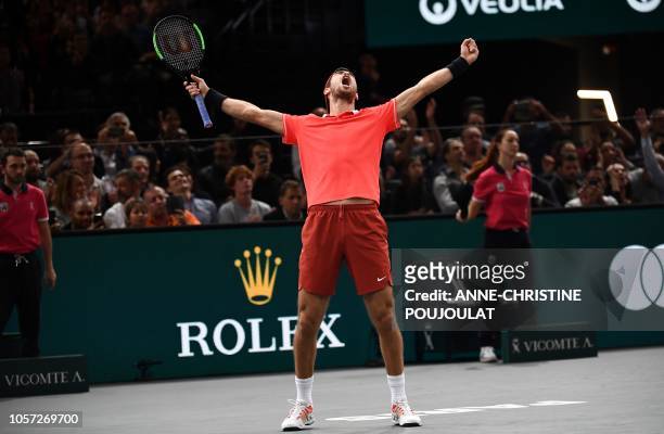Russia's Karen Khachanov celebrates after winning against Serbia's Novak Djokovic at the end of their men's singles final tennis match on day seven...