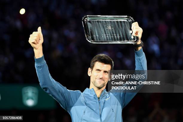 Second placed Serbia's Novak Djokovic poses with his trophy after the men's singles final tennis match against Russia's Karen Khachanov, on day seven...