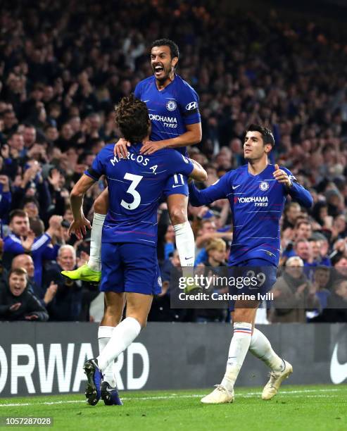 Pedro of Chelsea celebrates with teammates Marcos Alonso and Alvaro Morata after scoring his team's third goal during the Premier League match...