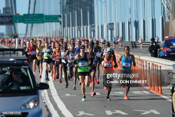 People run during the 47th running of the New York City Marathon on November 4, 2018 in New York. - Two-time Boston Marathon champion Lelisa Desisa...