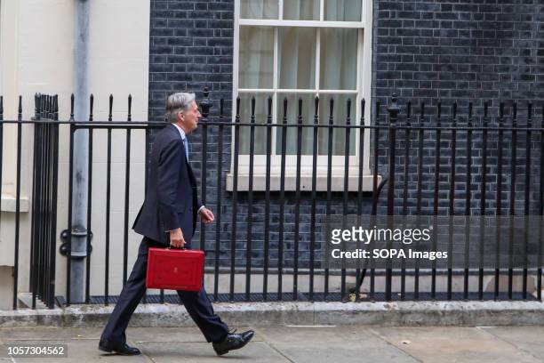 Chancellor of the Exchequer, Philip Hammond seen holding a famous red box while walking to the Palace of Westminster to deliver the budget to the...