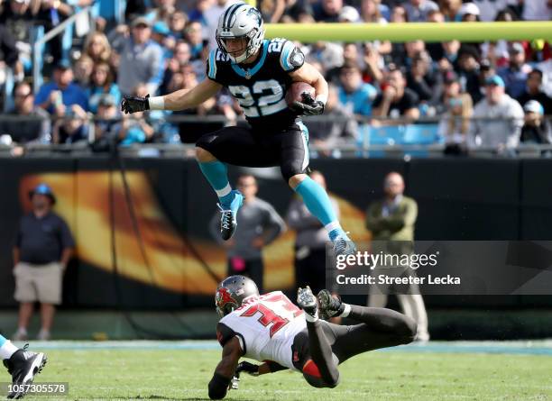 Christian McCaffrey of the Carolina Panthers runs the ball against Carlton Davis of the Tampa Bay Buccaneers in the first quarter during their game...