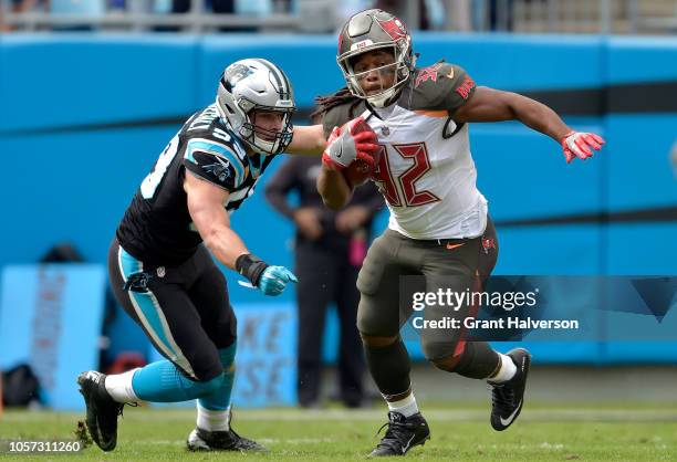 Jacquizz Rodgers of the Tampa Bay Buccaneers runs the ball against Luke Kuechly of the Carolina Panthers in the second quarter during their game at...