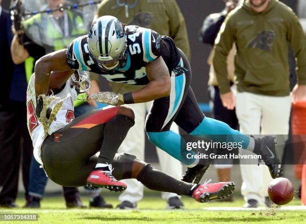 Shaq Green-Thompson of the Carolina Panthers breaks up a pass intended for Peyton Barber of the Tampa Bay Buccaneers during their game at Bank of...