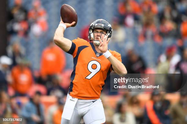 Quarterback Kevin Hogan of the Denver Broncos throws as he warms up before a game against the Houston Texans at Broncos Stadium at Mile High on...