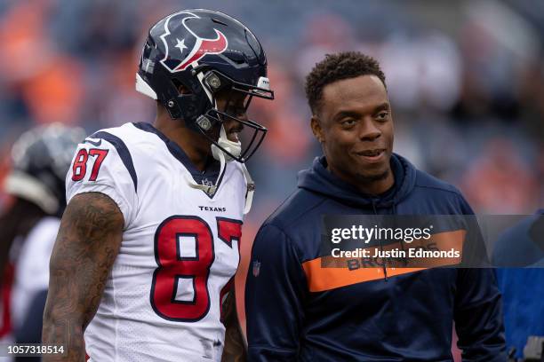 Wide receiver Demaryius Thomas of the Houston Texans talks with inside linebacker Brandon Marshall of the Denver Broncos during warm ups before a...