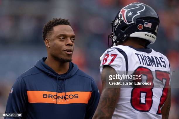 Wide receiver Demaryius Thomas of the Houston Texans talks with inside linebacker Brandon Marshall of the Denver Broncos during warm ups before a...